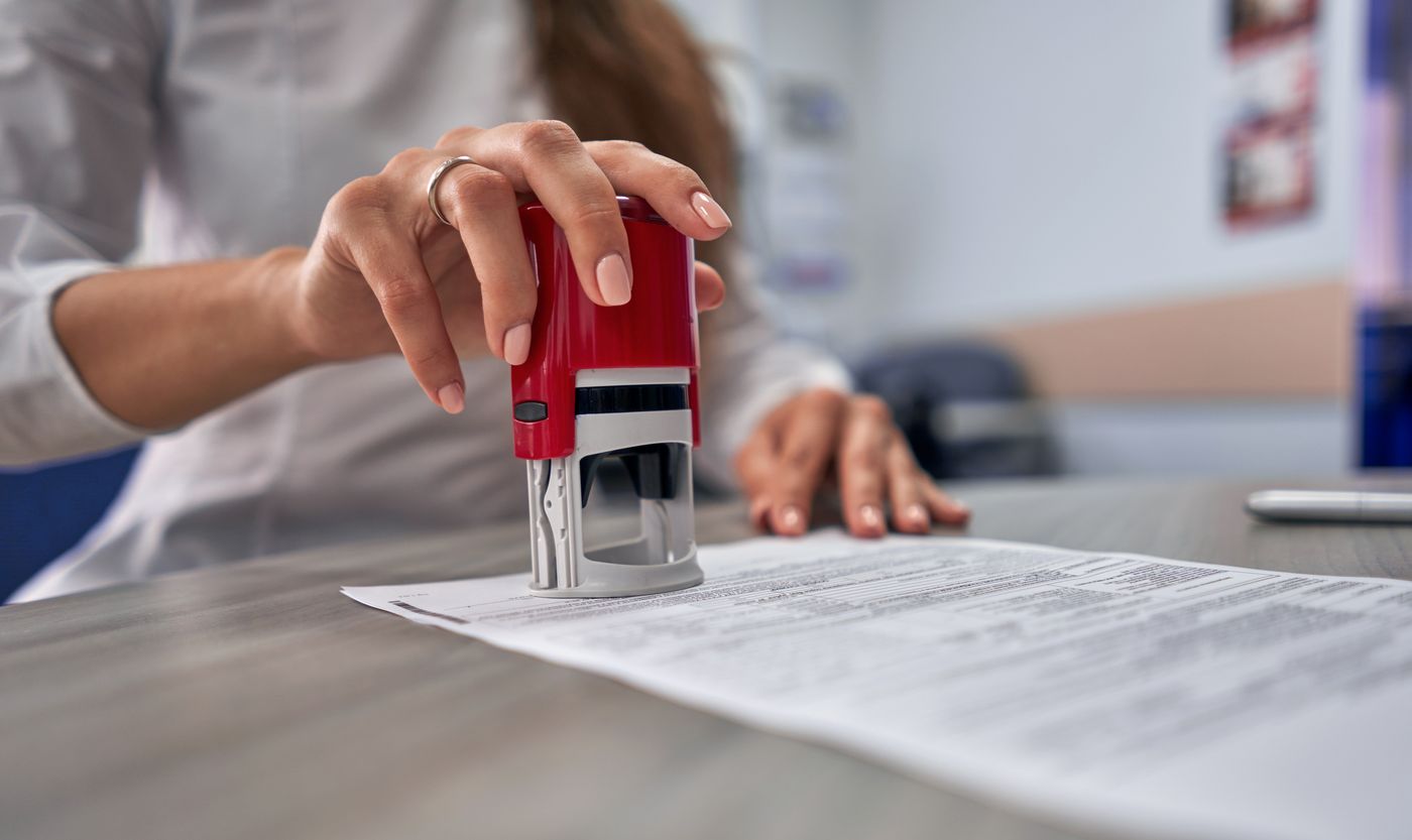 Notary stamping a signed document during an appointment in Edgewater, MD