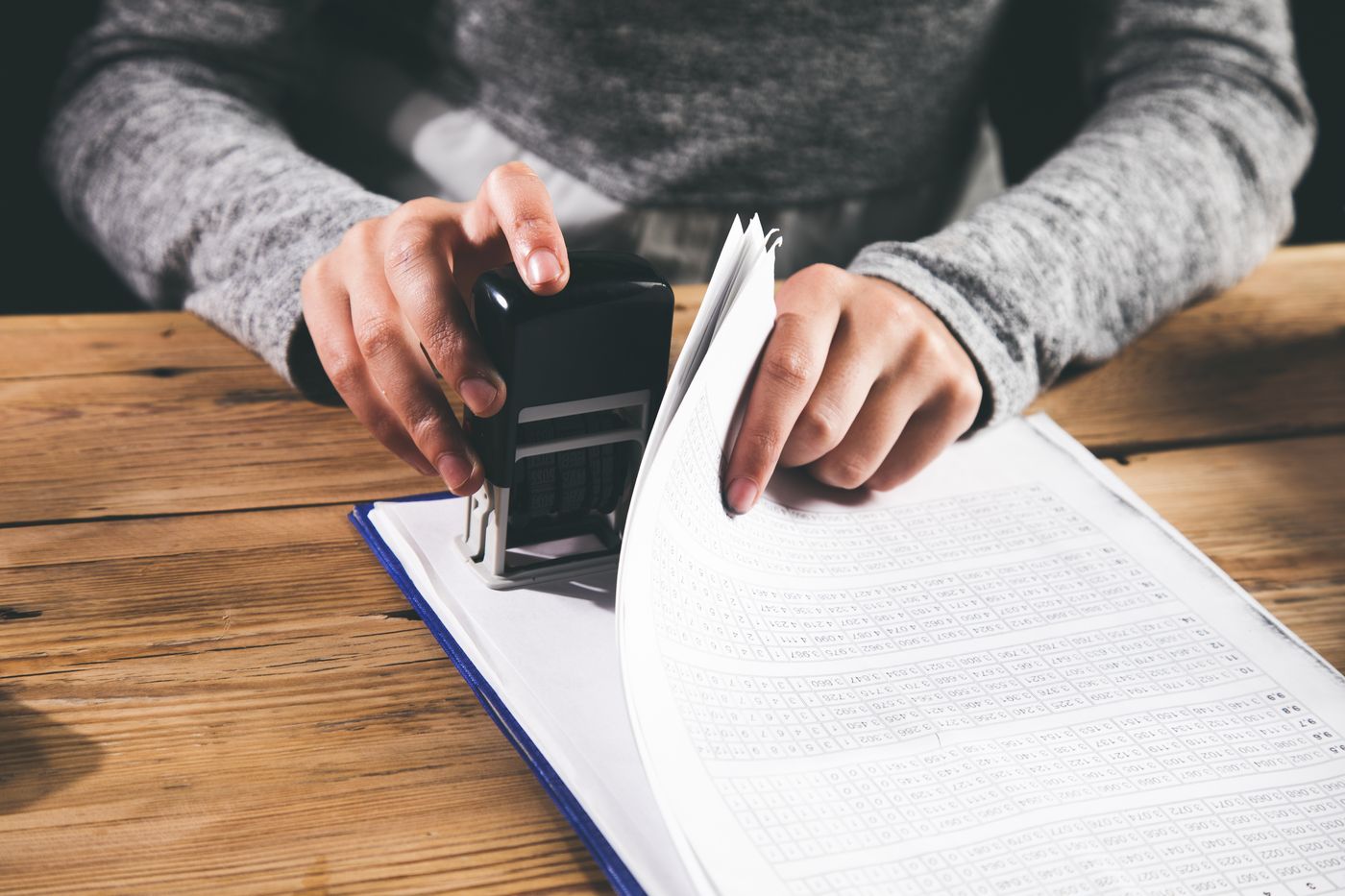 Notary stamping a stack of documents at a home in Crofton, MD